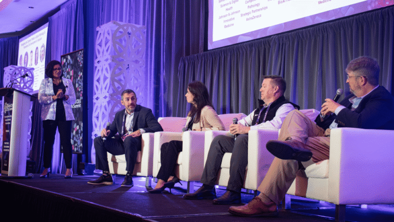 Industry experts participating in a panel discussion on a conference stage