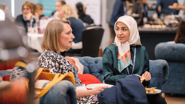 Conference attendees speaking during a professional networking session
