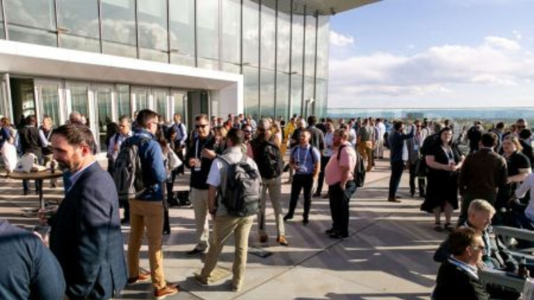 Attendees taking part in a roundtable networking session at a professional industry conference